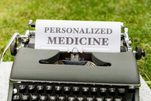 A vintage typewriter outdoors displaying a paper with the text 'Personalized Medicine'.